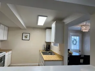 a kitchen with granite countertop a sink stove and cabinets