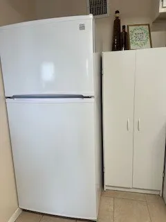 a view of a kitchen with cabinets and wooden floor