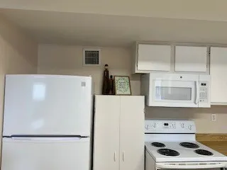 a white refrigerator freezer sitting in a kitchen