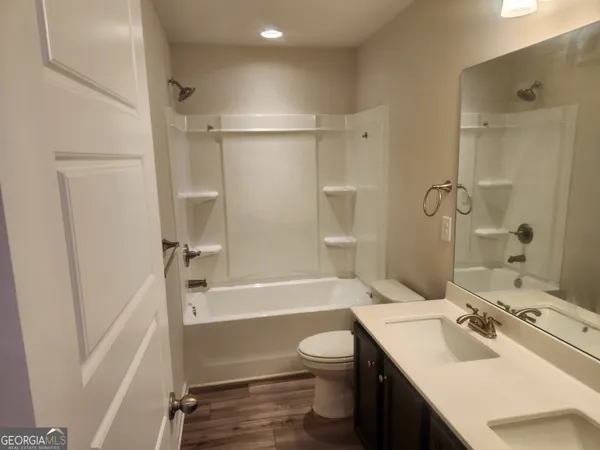 a bathroom with a sink toilet tub and shower