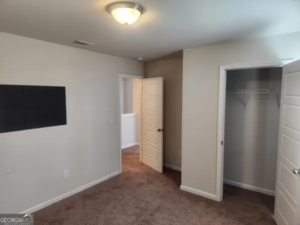 a view of an empty room with a bathroom