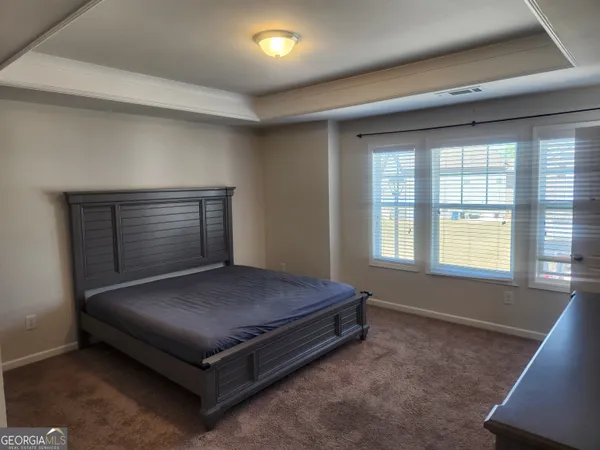 a bed sitting in a room next to a window