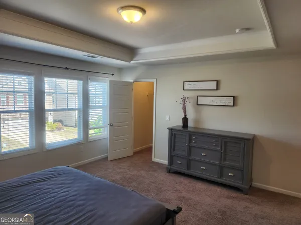 a room with a dresser and a window