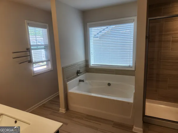 a bathroom with a tub and a shower