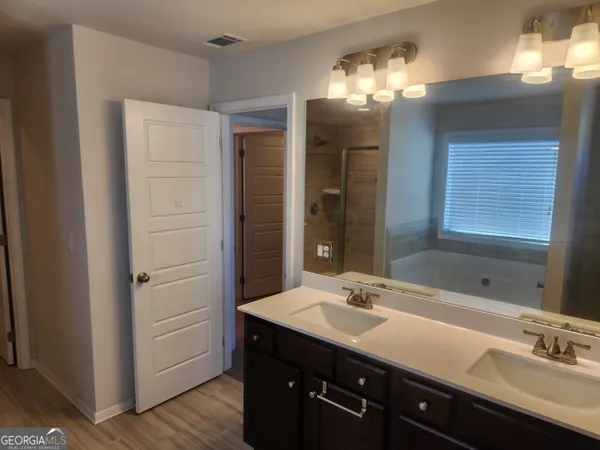 a bathroom with a sink double vanity and a mirror