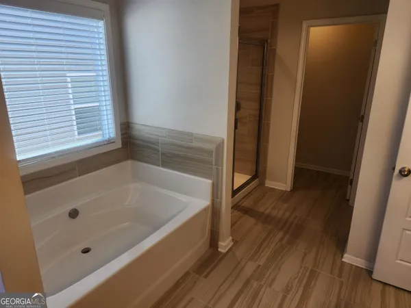 a bathroom with a bathtub and a shower