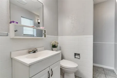 a bathroom with a sink toilet and a mirror
