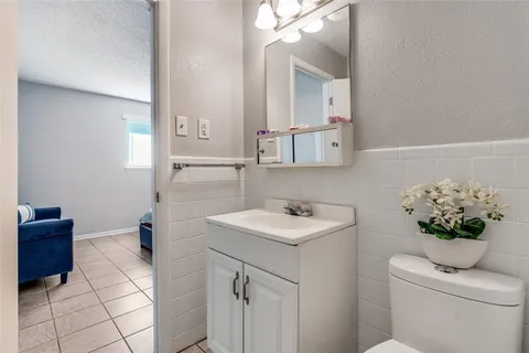 a bathroom with a sink a toilet and mirror