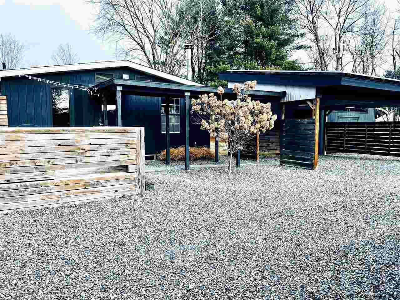 a view of a chairs and a table in the patio