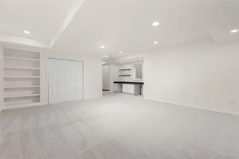 a view of an empty room with a cabinet and a window