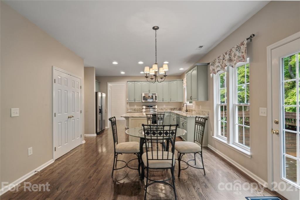 3028 Strawberry Road Matthews, NC 28104 - Photo 12 of 40 a view of a dining room with furniture window and wooden floor
