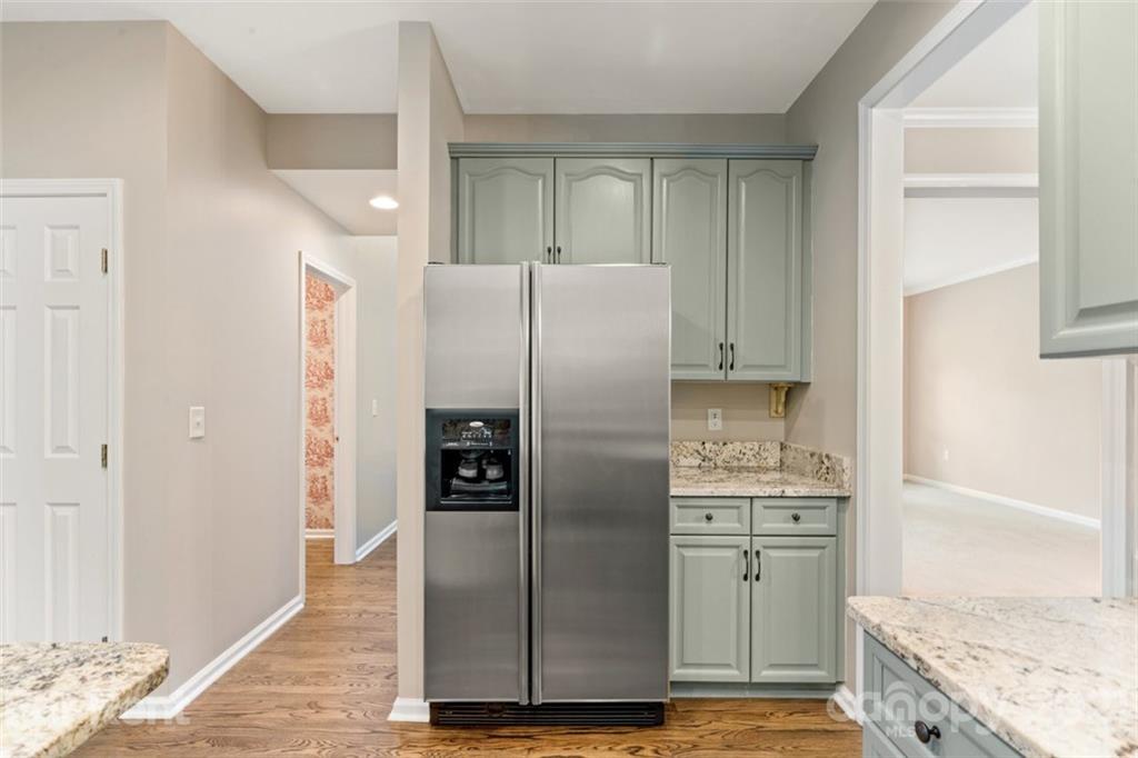 3028 Strawberry Road Matthews, NC 28104 - Photo 14 of 40 a kitchen with stainless steel appliances granite countertop a refrigerator and a stove