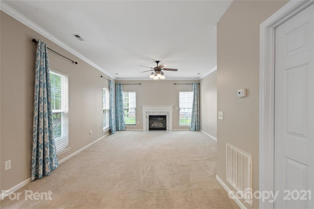 3028 Strawberry Road Matthews, NC 28104 - Photo 16 of 40 a view of an empty room with a fireplace and a window