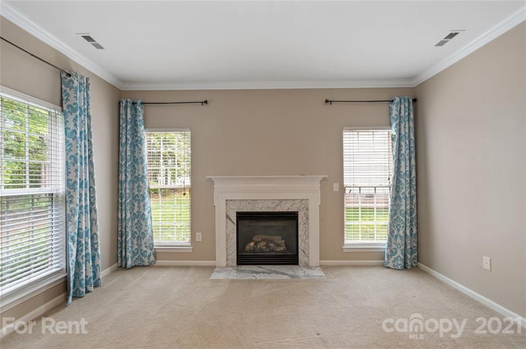 3028 Strawberry Road Matthews, NC 28104 - Photo 18 of 40 an empty room with windows and fireplace