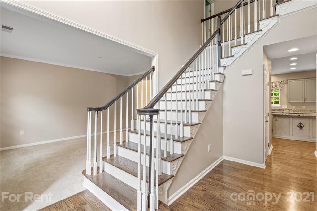 3028 Strawberry Road Matthews, NC 28104 - Photo 3 of 40 a view of entryway with wooden floor and a front door