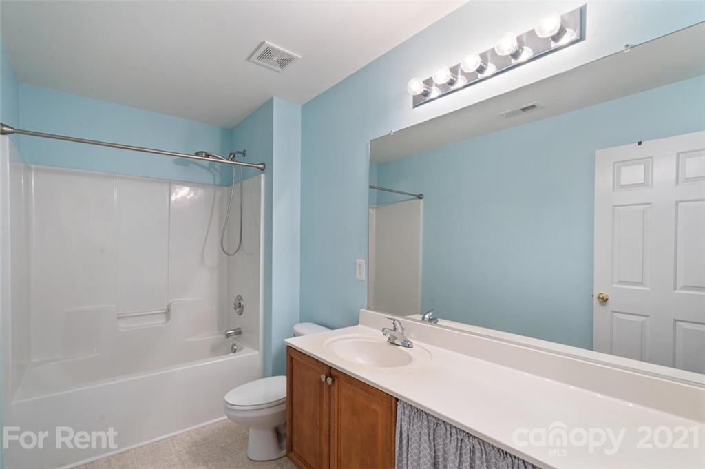 3028 Strawberry Road Matthews, NC 28104 - Photo 23 of 40 a bathroom with a sink a toilet and shower