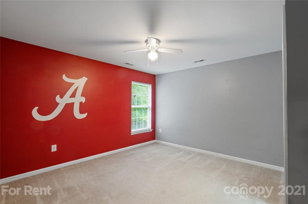 3028 Strawberry Road Matthews, NC 28104 - Photo 24 of 40 an empty room with windows and fan
