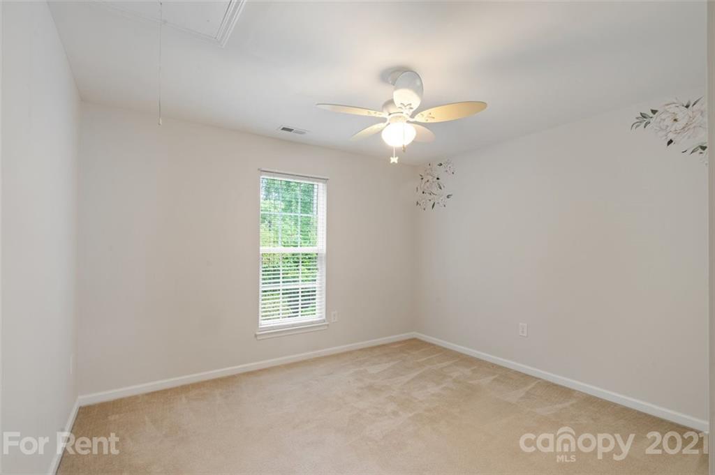 3028 Strawberry Road Matthews, NC 28104 - Photo 27 of 40 an empty room with a window and a fan