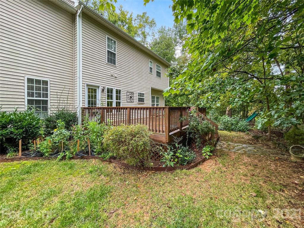 3028 Strawberry Road Matthews, NC 28104 - Photo 38 of 40 a view of a house with a yard and plants