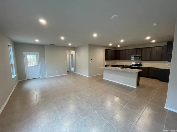 a view of kitchen with kitchen island and stainless steel appliances
