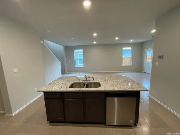 a bathroom with a granite countertop sink
