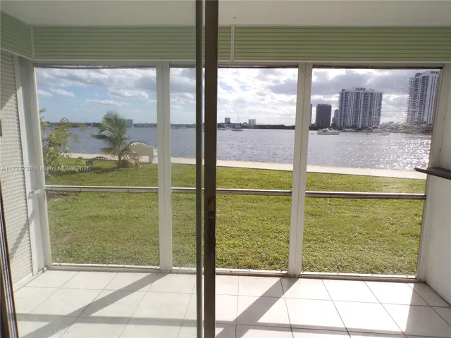 a kitchen with a sink a refrigerator and cabinets