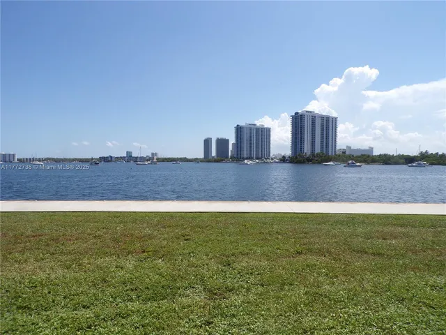 a view of a lake with houses in the back