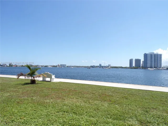 a view of a lake with houses in the back