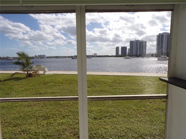 an empty room with kitchen view