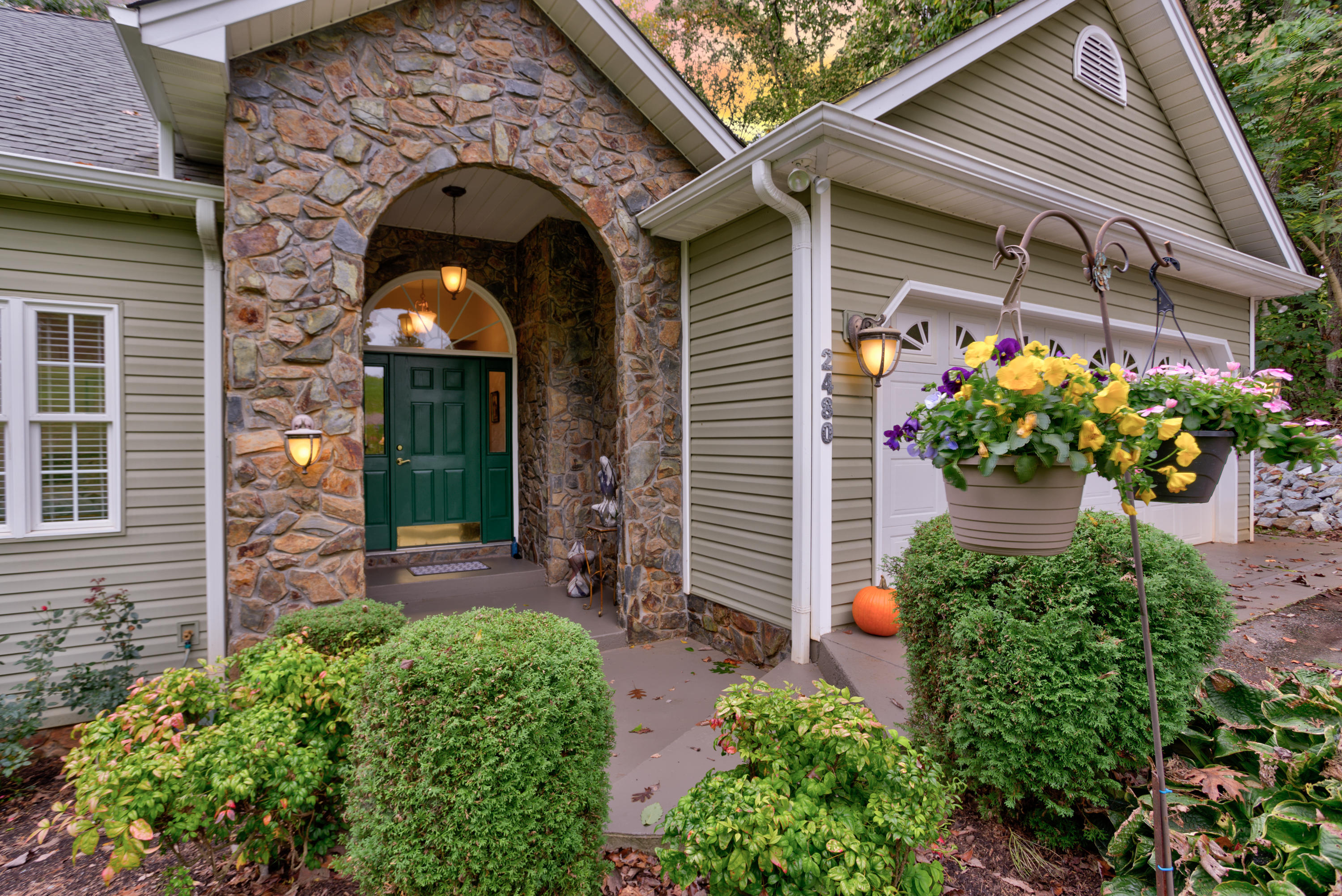 2480 Iron Ridge Road Rocky Mount, VA 24151 - Photo 14 of 38 a front view of a house with a garden