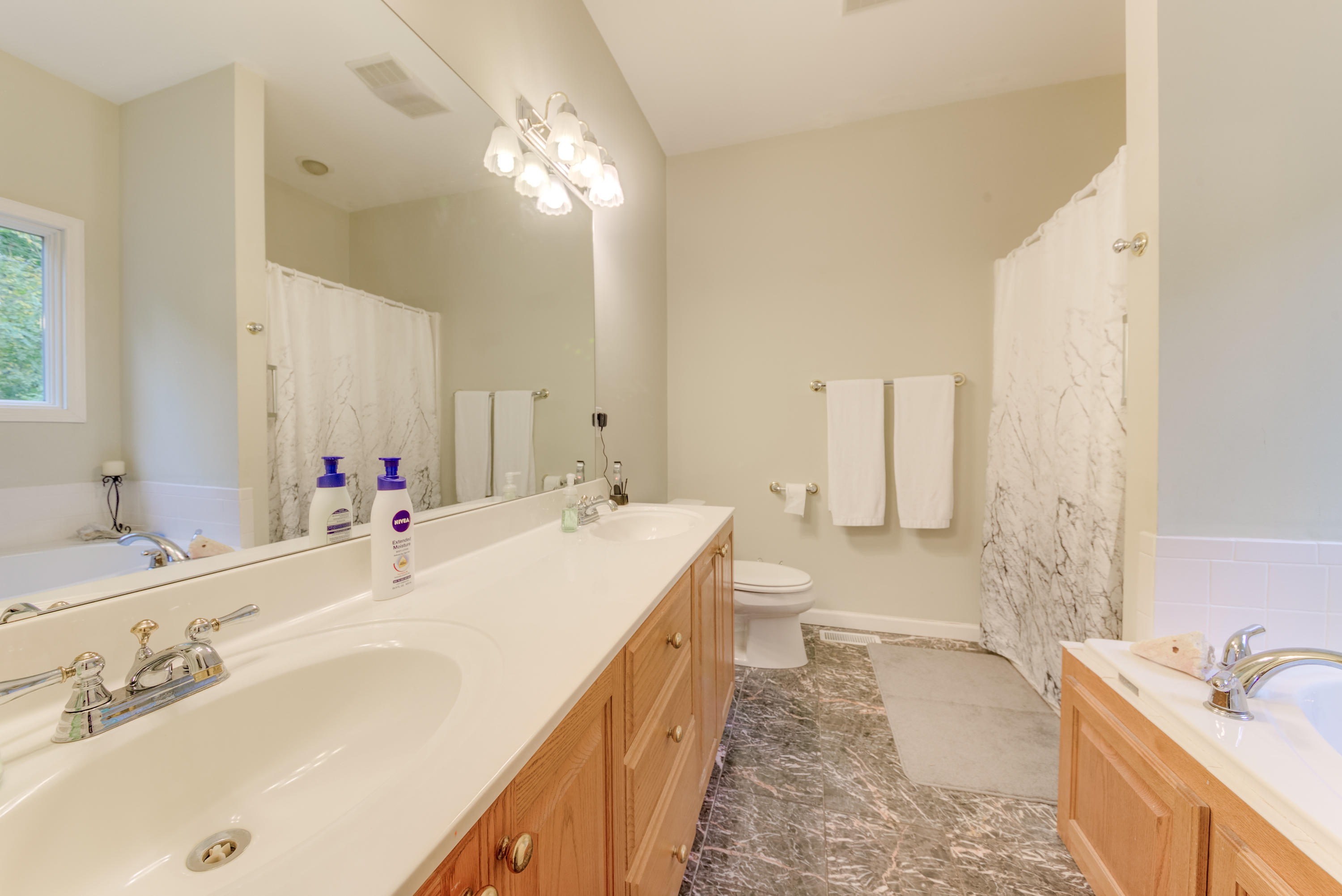 2480 Iron Ridge Road Rocky Mount, VA 24151 - Photo 30 of 38 a spacious bathroom with a double vanity sink mirror and bathtub