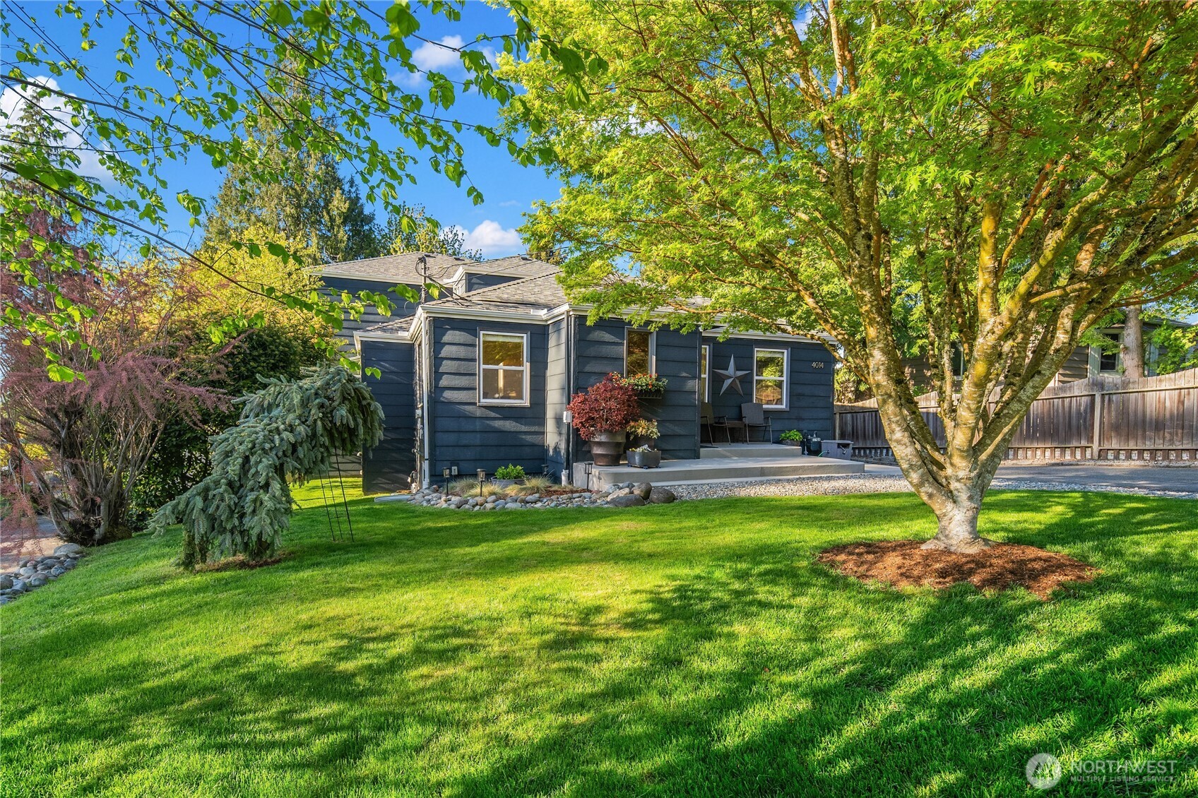 4014 Southwest 98th Street Seattle, WA 98136 - Photo 2 of 36 a view of house with a big yard potted plants and large tree