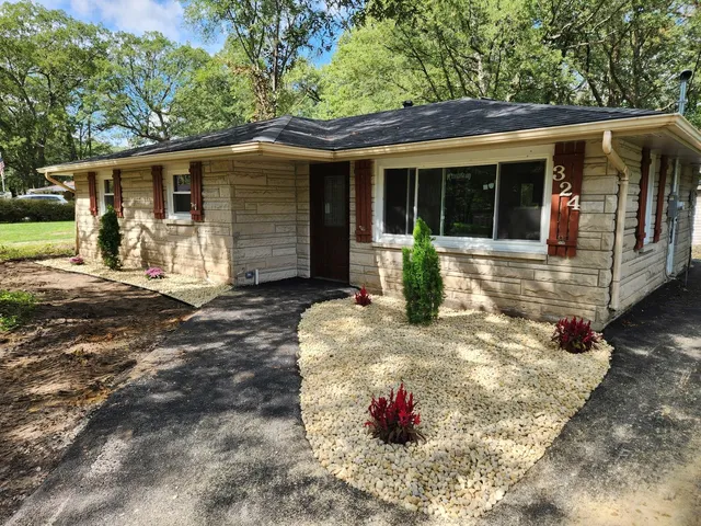a front view of a house with yard