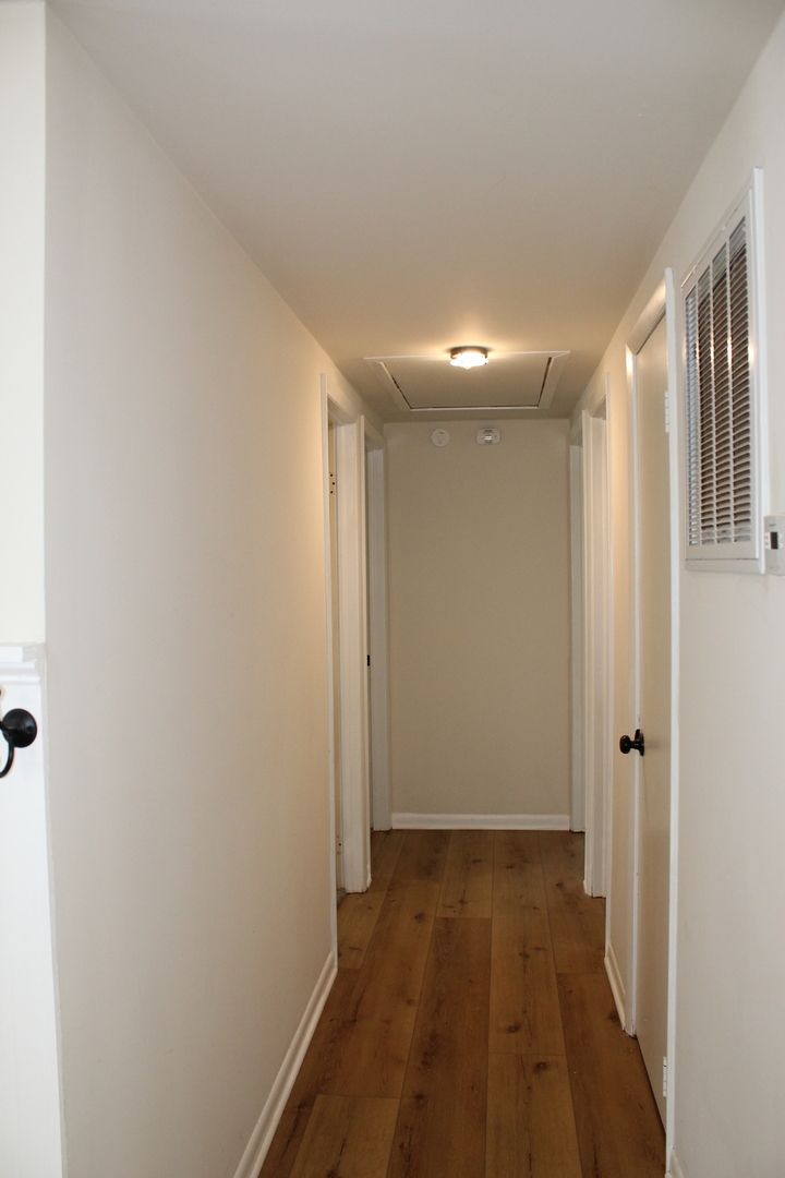 324 Sumac Street Wilmington, IL 60481 - Photo 12 of 23 a view of a hallway with wooden floor