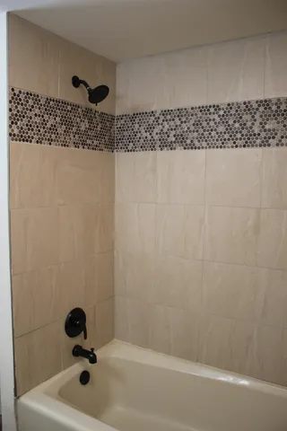 a bathroom with a bathtub and shower