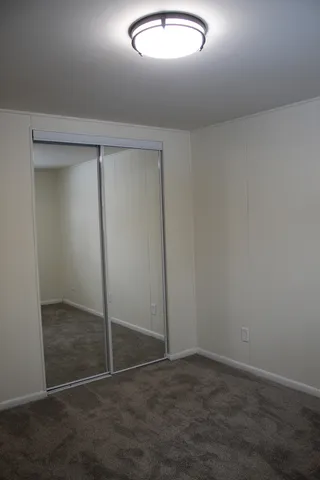 an empty room with closet area