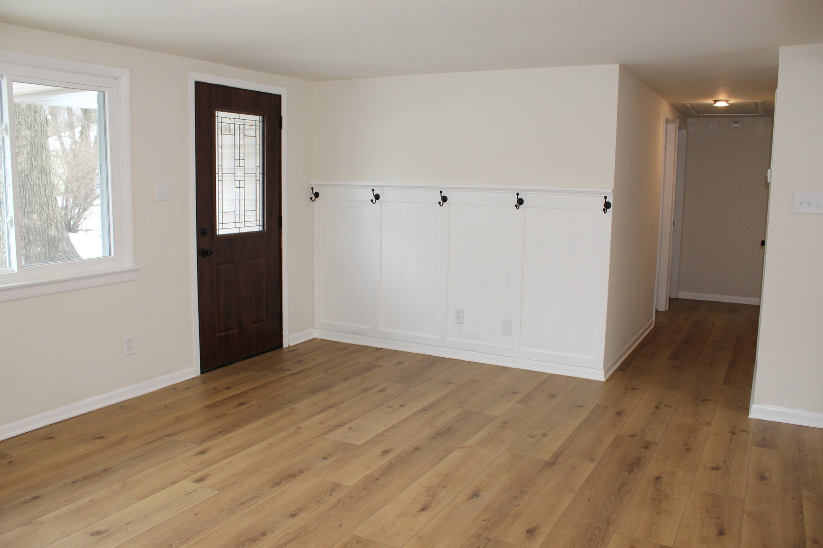 324 Sumac Street Wilmington, IL 60481 - Photo 4 of 23 a view of an empty room with wooden floor and windows