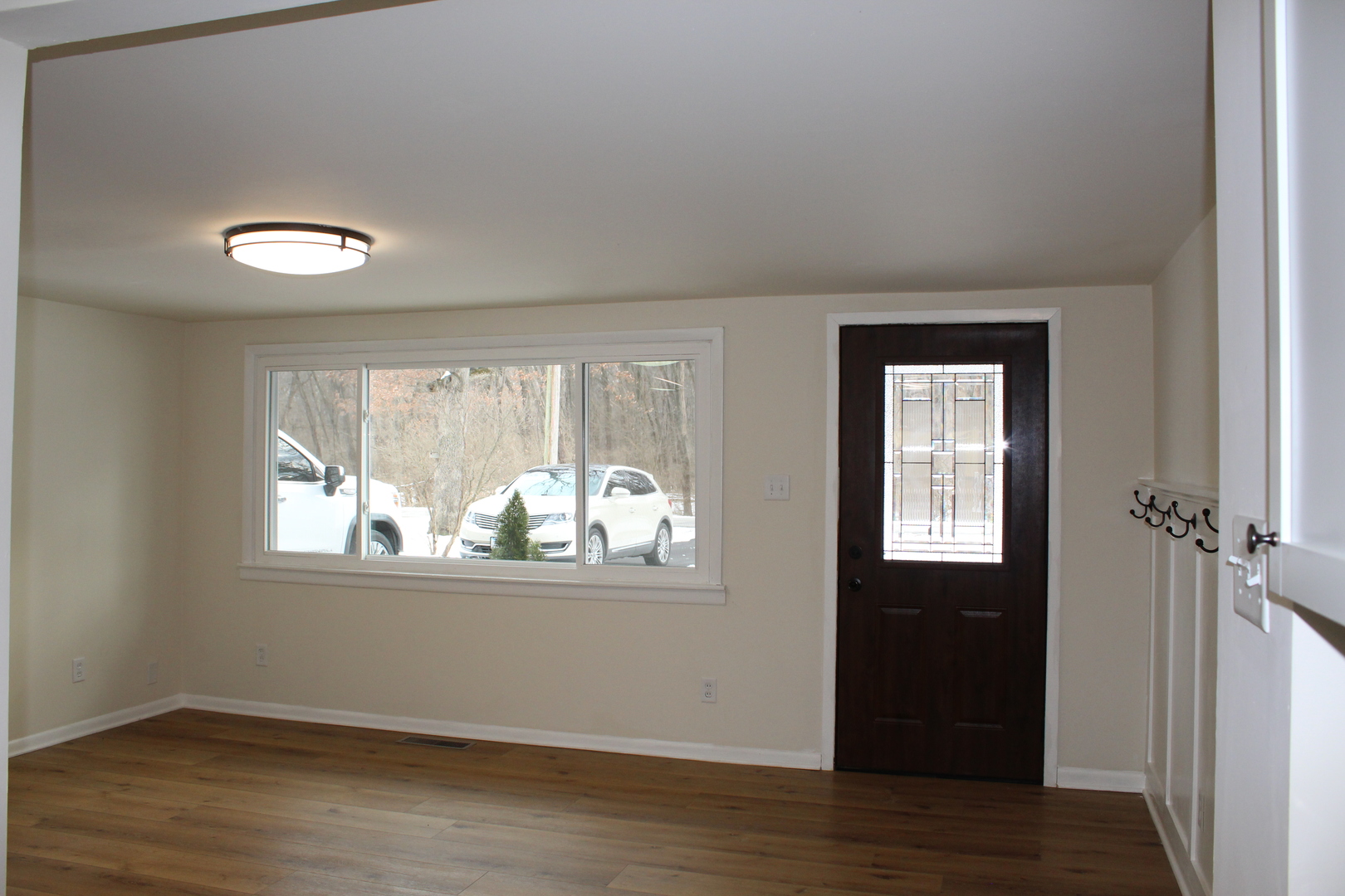 324 Sumac Street Wilmington, IL 60481 - Photo 5 of 23 an empty room with wooden floor and windows