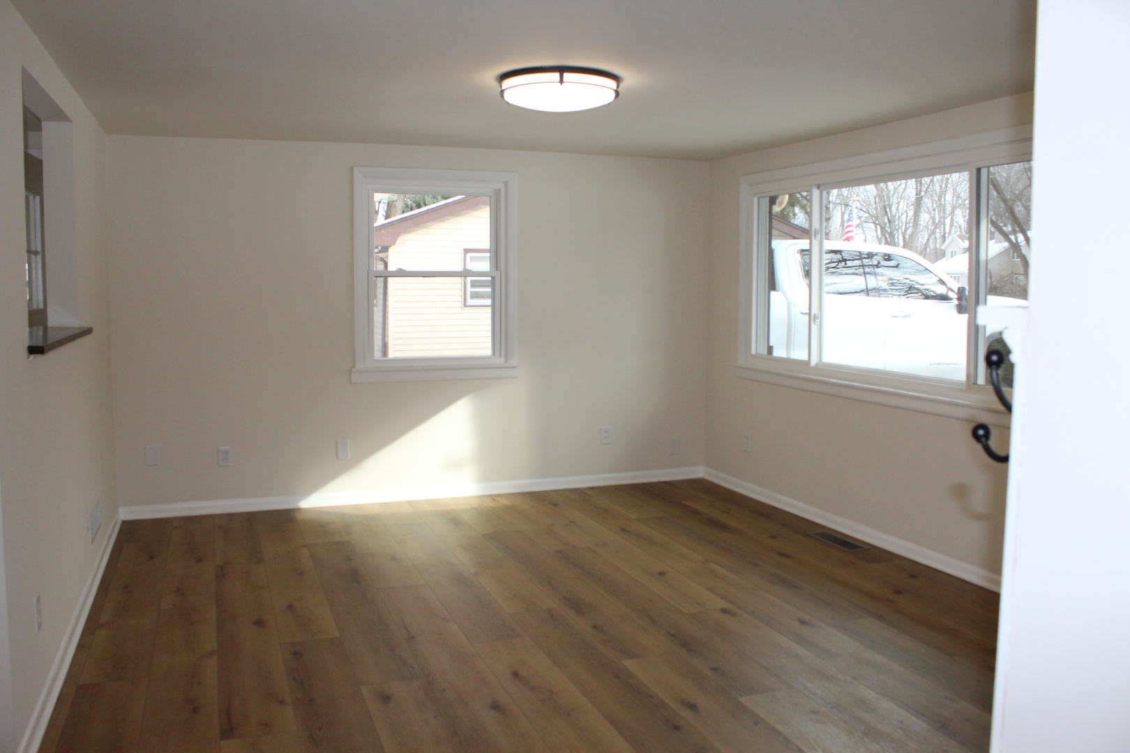 324 Sumac Street Wilmington, IL 60481 - Photo 6 of 23 an empty room with wooden floor and windows