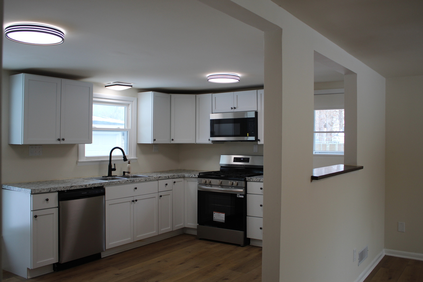 324 Sumac Street Wilmington, IL 60481 - Photo 7 of 23 a kitchen with granite countertop a sink cabinets and stainless steel appliances