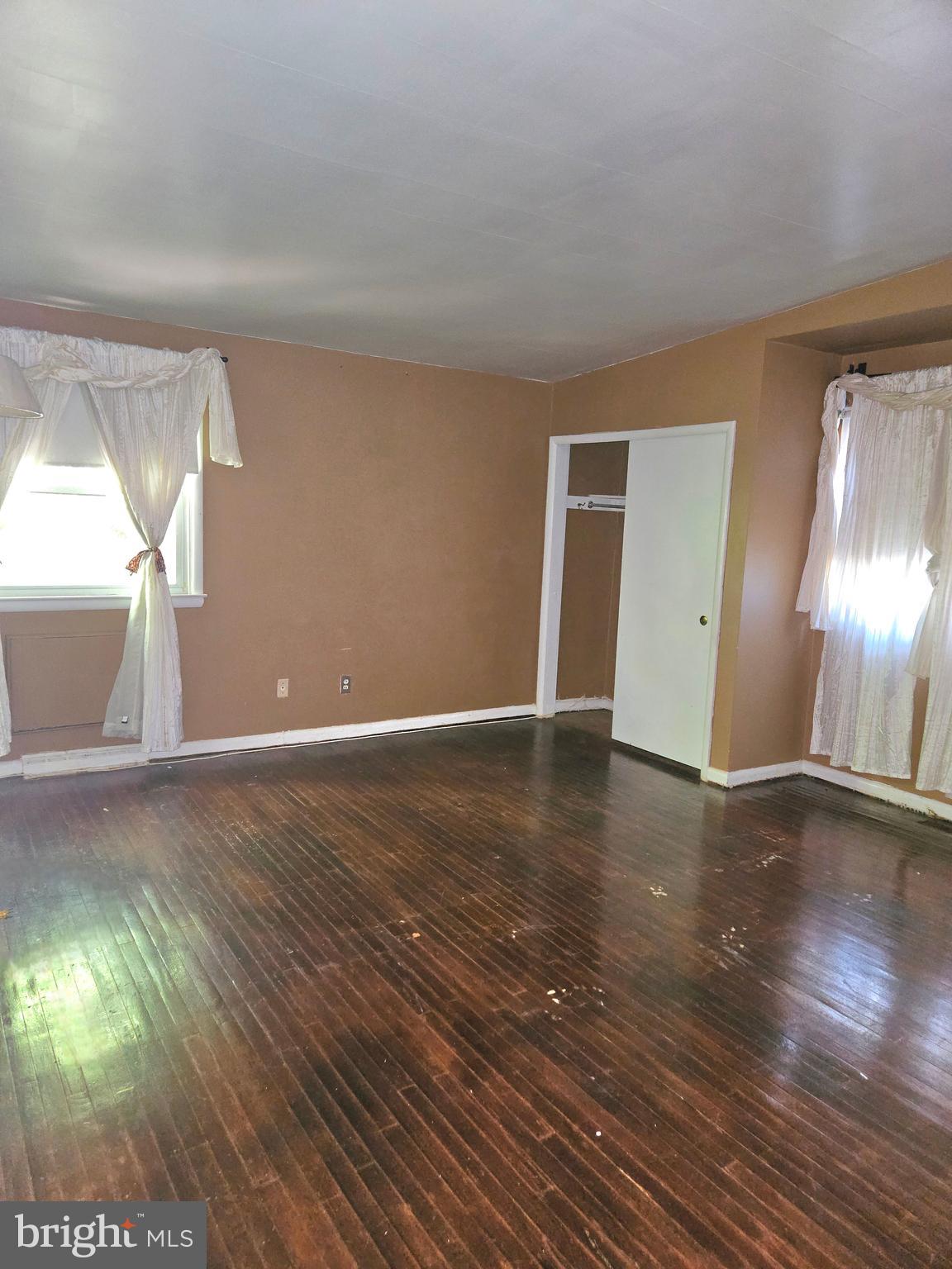 148 Church Road Elkins Park, PA 19027 - Photo 16 of 33 a view of an empty room with wooden floor and a window