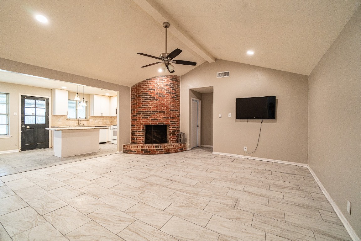 7406 Baneway Drive Houston, TX 77072 - Photo 11 of 22 a view of empty room with fireplace and wooden floor