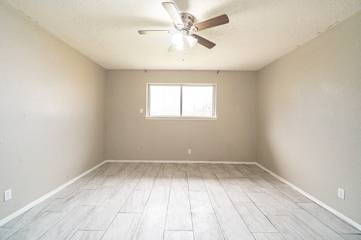 7406 Baneway Drive Houston, TX 77072 - Photo 13 of 22 wooden floor in an empty room with a window