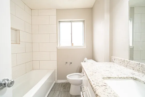 a bathroom with a sink toilet and bathtub