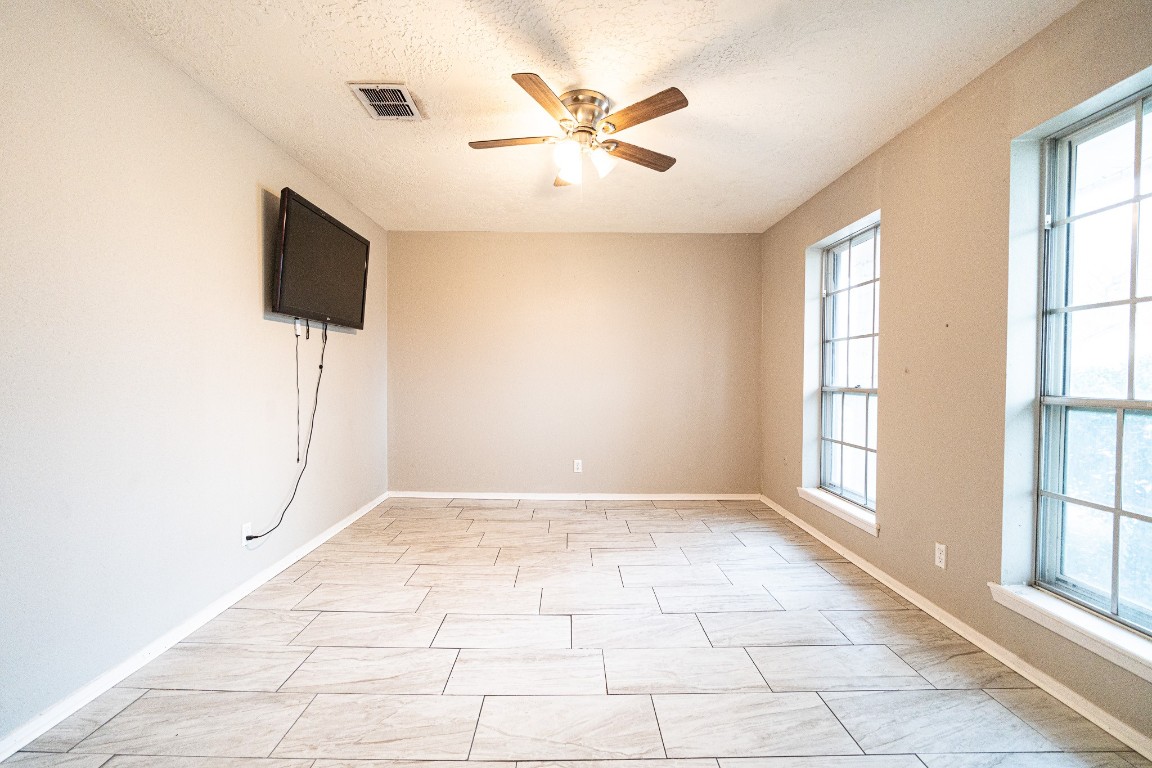 7406 Baneway Drive Houston, TX 77072 - Photo 2 of 22 wooden floor in an empty room with a window