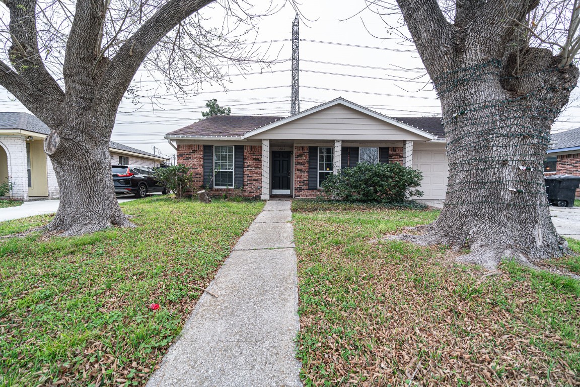 7406 Baneway Drive Houston, TX 77072 - Photo 21 of 22 a front view of a house with yard and green space