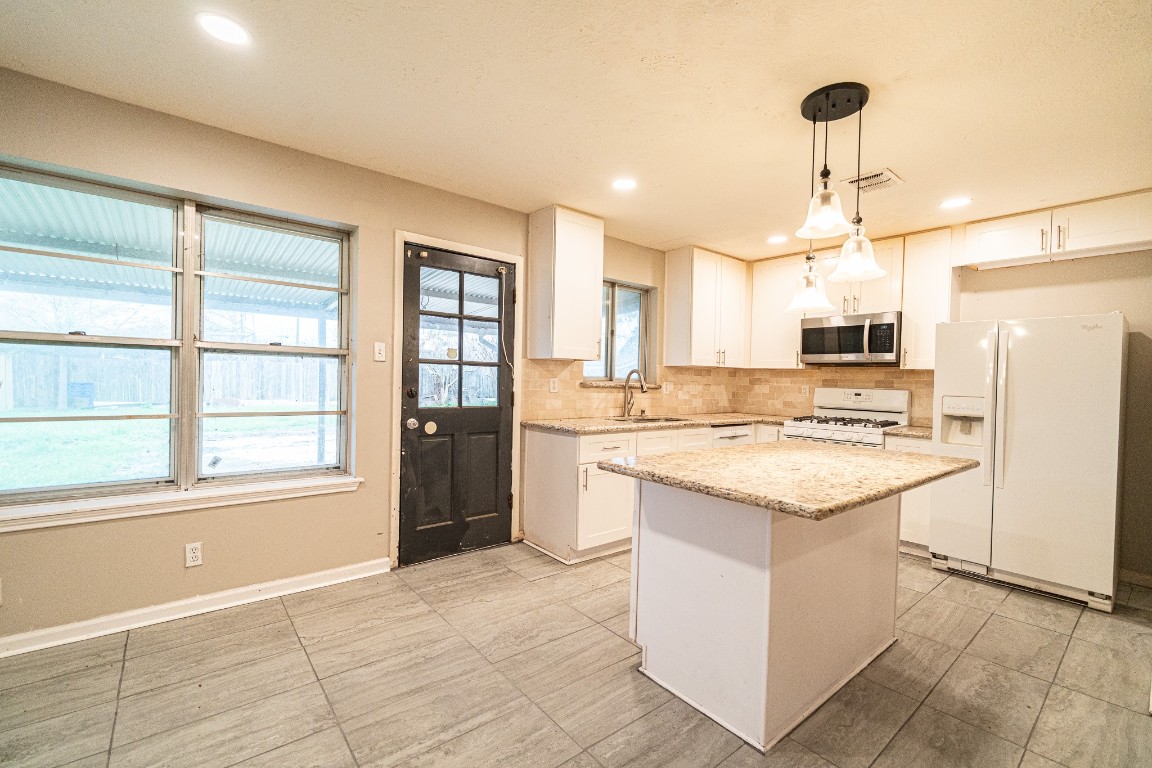 7406 Baneway Drive Houston, TX 77072 - Photo 6 of 22 a kitchen with a stove a refrigerator and a sink