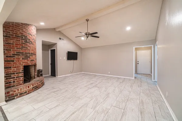 a view of an empty room with a fireplace