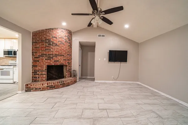 a view of an empty room with a fireplace