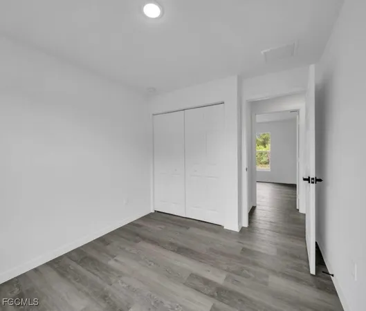 a view of an empty room and wooden floor